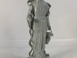 statue of a woman holding a bird and a flower in her hand