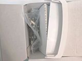 a white microwave sitting inside of a box on a table