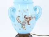 a blue vase with a monkey on it on a table