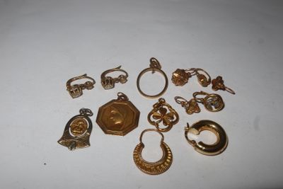 a lot of gold jewelry on a white surface