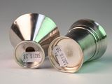 two metal containers with labels on them sitting on a table