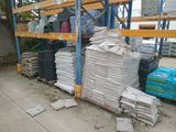 a pile of bags of cement sitting on a rack
