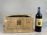 a bottle of wine sitting next to a box of wine