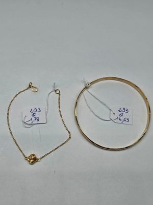 three pieces of jewelry on a white surface with a price tag