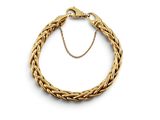 un bracelet en galon doré avec une chaîne, sur fond blanc