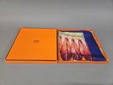 an orange box with a picture of feathers in it on a table