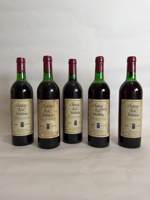 four bottles of wine are lined up on a table