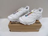 salomon shoes in a box on a white surface