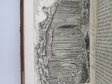 an open book with a drawing of a building on it