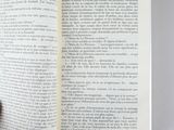someone is holding a book open to a page with a picture of a cat on it