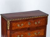 a small chest of drawers on a white background