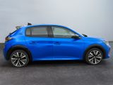 the blue car is parked in a parking lot near a building