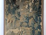 an image of a tapestry hanging on a wall with birds flying over it