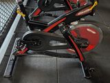 a row of stationary exercise bikes in a gym