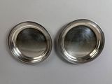 pair of silver plated dishes on a white surface