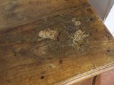 a wooden table with a brown stain on the top of it