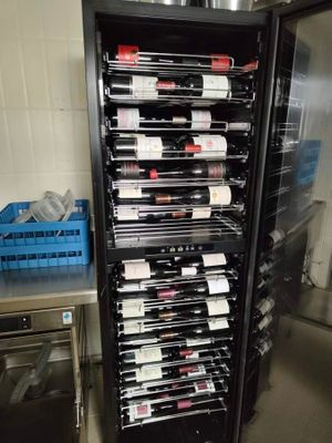 many bottles of wine on the shelves in the kitchen