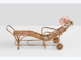 an image of a wooden chaise with flowers on top of it