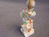 a figurine of a man with a dog on a table