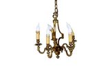 a close up of a chandelier with three candles on it