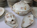 a lot of plates and bowls that are on a table