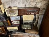 a pile of old radio ' s sitting on top of each other