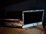 a computer monitor sitting on top of a wooden desk