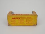 a close up of a box of dinky toys on a white surface