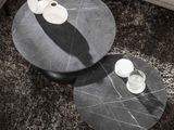 two tables that are sitting on a rug in a living room