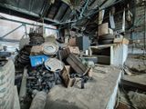 a pile of junk in a warehouse with a lot of boxes