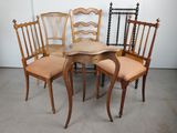 quatre chaises et une table dans une pièce aux murs blancs