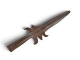 an old, rusty knife with a wooden handle on a white surface