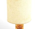 a lamp that is sitting on a table with a lamp shade on it