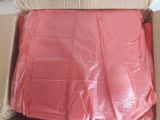 a cardboard box with a pink cloth inside of it
