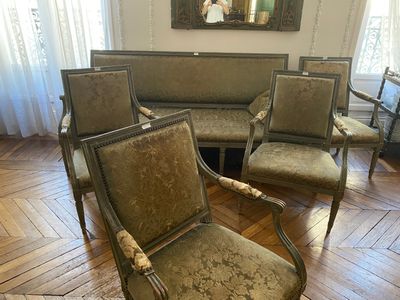 four chairs in a room with a mirror on the wall