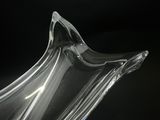 a clear glass vase with a curved design on it