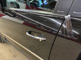a close up of a car door handle with a sticker on it