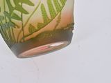 a glass vase with a green and white design on it