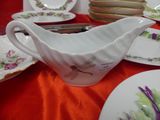 a white gravy sitting on top of a red table