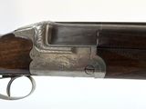 a close up of a gun with a wooden handle