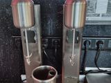 a coffee maker and a cup on a counter