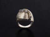 a close up of a silver ring on a black surface