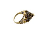 a close up of a gold ring with black stones on it