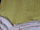 a close up of a chair with a green cushion on it