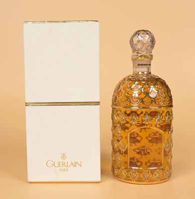 an image of a bottle of perfume sitting next to a box