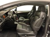 the interior of a car with the door open and the driver ' s seat down