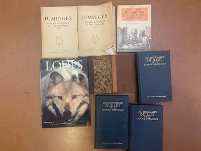 several books are sitting on a table next to each other
