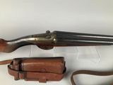 an old gun with a leather case and a leather belt