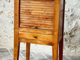 a small wooden table with a drawer on top of it