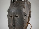 an image of a wooden mask with spikes on it ' s head